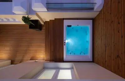 a room with a large blue pool in the wall at Praxitelous Luxury Suites in Athens