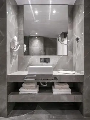 a bathroom with a sink and a mirror at Praxitelous Luxury Suites in Athens