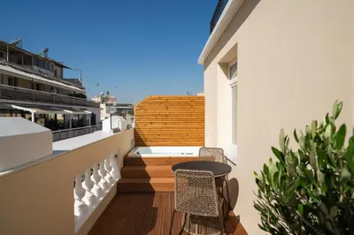 a balcony with a table and chairs on a building at Praxitelous Luxury Suites in Athens