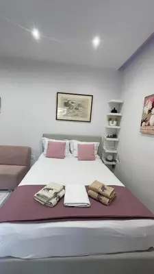 a bedroom with a large bed with towels on it at Athens Anasa's Studio in Athens