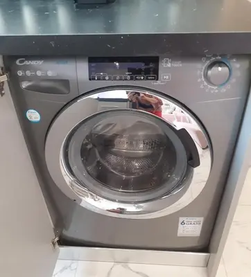 a washing machine with its door open in a room at Athens Anasa's Studio in Athens