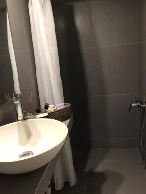 a bathroom with a white sink and a shower at ATHENS RIVIERA Grand Panoramic Villa Lagonissi in Lagonissi