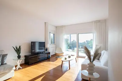 a living room with a couch and a tv at ATHENS RIVIERA Grand Panoramic Villa Lagonissi in Lagonissi