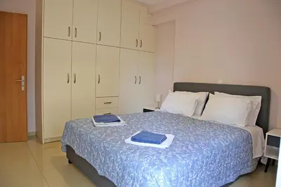 a bedroom with a bed with two towels on it at 2 Bedroom Apartment near the Athens Airport, Spata in Spáta