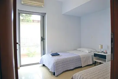 a bedroom with a bed and a window at 2 Bedroom Apartment near the Athens Airport, Spata in Spáta