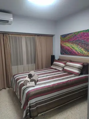 a bedroom with a large bed with towels on it at Praxitelous Apartments by Athens Urban Retreat in Athens