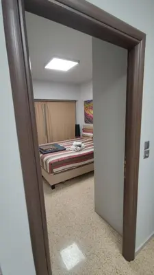 a reflection of a bedroom with a bed in a mirror at Praxitelous Apartments by Athens Urban Retreat in Athens