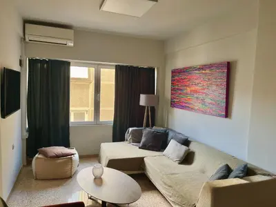 a living room with a couch and a table at Praxitelous Apartments by Athens Urban Retreat in Athens