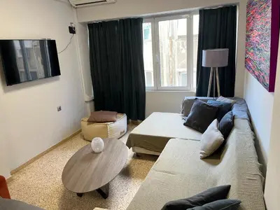 a living room with a couch and a table at Praxitelous Apartments by Athens Urban Retreat in Athens