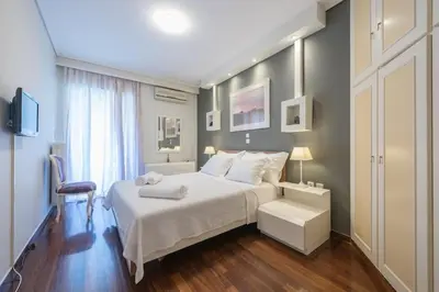 a bedroom with a large white bed and a window at Central 3BR Apartment Next to Panormou Metro! in Athens