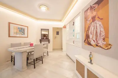 a dining room with a table and a painting on the wall at Central 3BR Apartment Next to Panormou Metro! in Athens