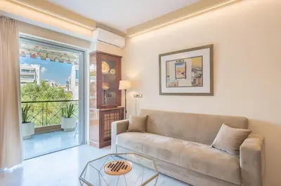 a living room with a couch and a glass table at Central 3BR Apartment Next to Panormou Metro! in Athens