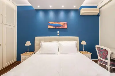 a bedroom with a blue wall and a bed at Central 3BR Apartment Next to Panormou Metro! in Athens