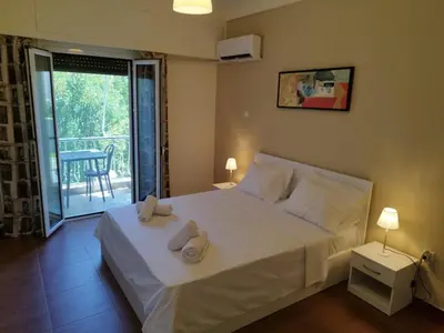 a bedroom with a bed with two towels on it at Zeus Apartment in Athens