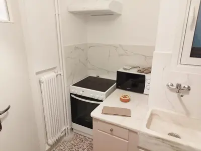 a small kitchen with a stove and a sink at Zeus Apartment in Athens