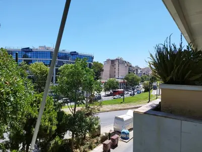a view of a city street from a balcony at Zeus Apartment in Athens