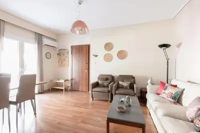 a living room with a couch and a table at Heart of Koukaki flat, near Acropolis & Filopappou in Athens