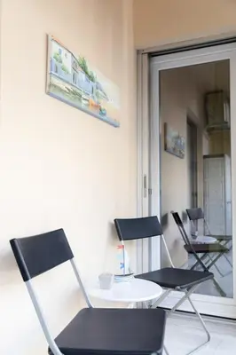 two chairs and a table in a room at Heart of Koukaki flat, near Acropolis & Filopappou in Athens