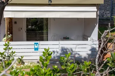 a white fence in front of a house at Homeyfeel Stay Sea 2 - Island mood studio in Porto Rafti