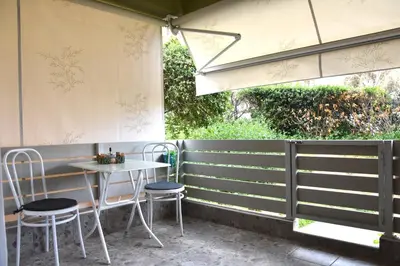 a patio with a table and chairs and a window at Homeyfeel Stay Sea 2 - Island mood studio in Porto Rafti