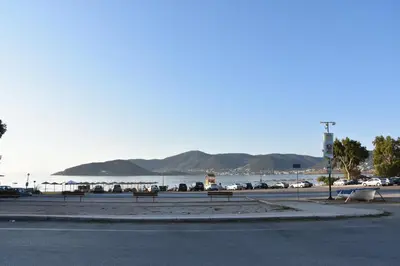 a street with benches in front of the water at Homeyfeel Stay Sea 2 - Island mood studio in Porto Rafti