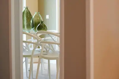 a table with four green glass vases on top of it at Ma Maison No6 Acropolis View Mansion,3bdrs,400Mbps in Athens
