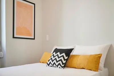 a bedroom with a white bed with pillows on it at Ma Maison No6 Acropolis View Mansion,3bdrs,400Mbps in Athens
