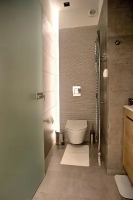 a bathroom with a white toilet and a shower at Athelia Athens in Athens
