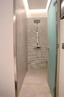 a bathroom with a shower with a glass door at Athelia Athens in Athens