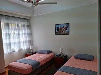 a bedroom with two beds and a picture on the wall at STADION APTS Near Athens City Center in Athens