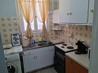 a small kitchen with a stove and a sink at STADION APTS Near Athens City Center in Athens
