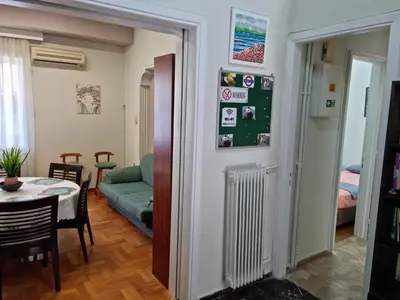a living room with a table and a couch at STADION APTS Near Athens City Center in Athens
