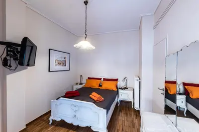 a bedroom with a bed with orange pillows at Ami's Appartment in Athens in Athens