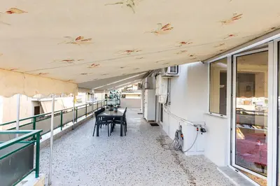 a room with a table and chairs on a building at Ami's Appartment in Athens in Athens
