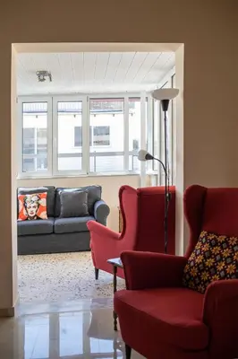 a living room with red chairs and a couch at Ami's Appartment in Athens in Athens