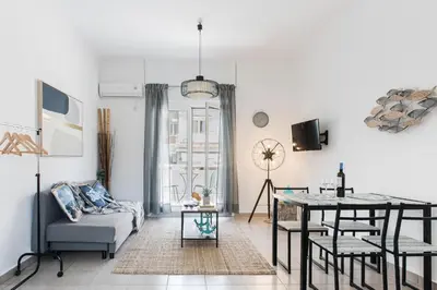 a living room with a couch and a table at Aegean style, city center studio next to Acropolis in Athens