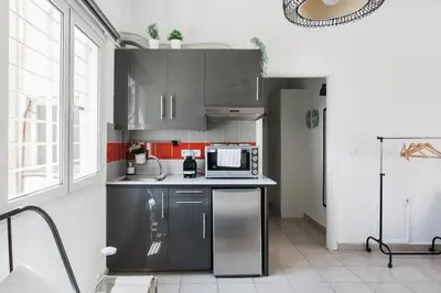 a kitchen with stainless steel cabinets and a microwave at Aegean style, city center studio next to Acropolis in Athens