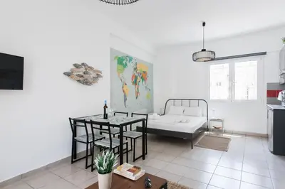 a living room with a bed and a table at Aegean style, city center studio next to Acropolis in Athens