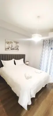 a bedroom with a large white bed with white sheets at Athens' Secret Jewel by YHA in Athens