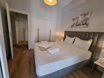 a bedroom with a large bed with white sheets at Athens' Secret Jewel by YHA in Athens