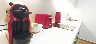 a kitchen with a red coffee maker on a counter at Athens' Secret Jewel by YHA in Athens