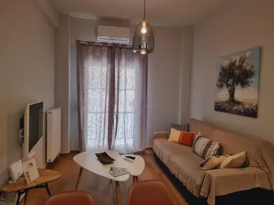 a living room with a couch and a table at Athens' Secret Jewel by YHA in Athens