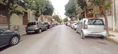 a street with cars parked on the side of the road at Athens' Secret Jewel by YHA in Athens
