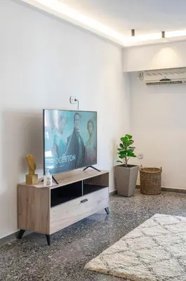 a living room with a flat screen tv on a wall at Lovely 2 bedroom rental in excellent location in Athens