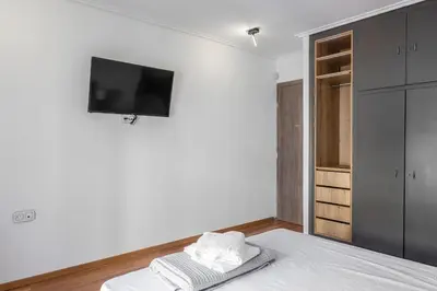 a bedroom with a bed with a tv on the wall at Lovely 2 bedroom rental in excellent location in Athens
