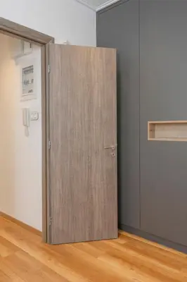 a wooden door in the corner of a room at Lovely 2 bedroom rental in excellent location in Athens