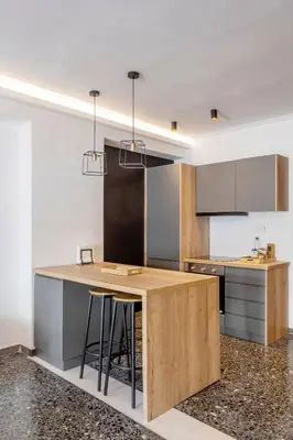 a kitchen with a wooden island with bar stools at Lovely 2 bedroom rental in excellent location in Athens