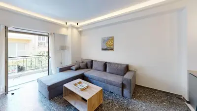 a living room with a couch and a table at Lovely 2 bedroom rental in excellent location in Athens