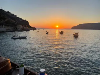 a group of boats in the water at sunset at AIOLOS LUXURY alimos kalamaki market apartment 3 near the sea in Athens