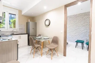 a kitchen and dining room with a table and chairs at AIOLOS LUXURY alimos kalamaki market apartment 3 near the sea in Athens